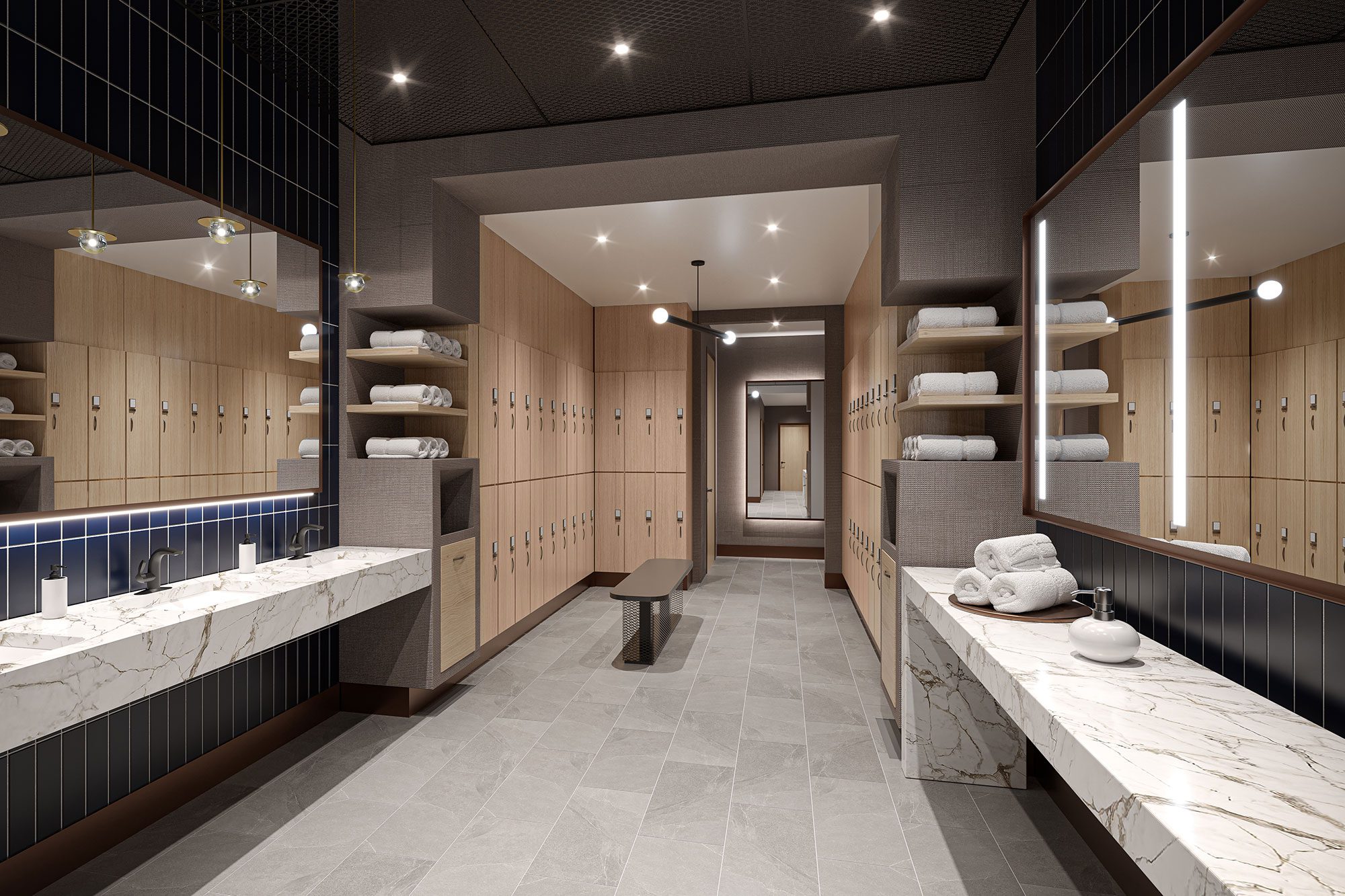 A luxury tenant locker room with long mirrors and marble sinks