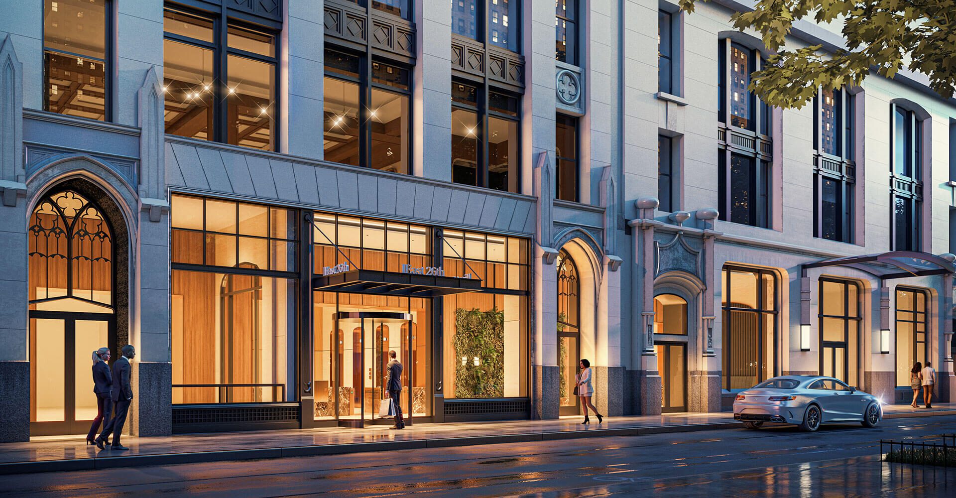 Sidewalk view of people outside of a beautiful NYC building